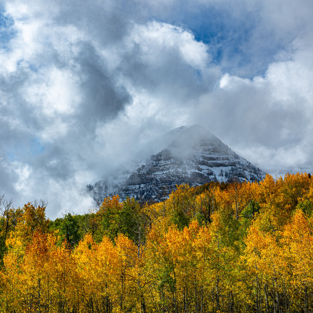 Mount Timpanogos poking though clouds on stormy autumn day - Copyright Randy G. Barney Photography