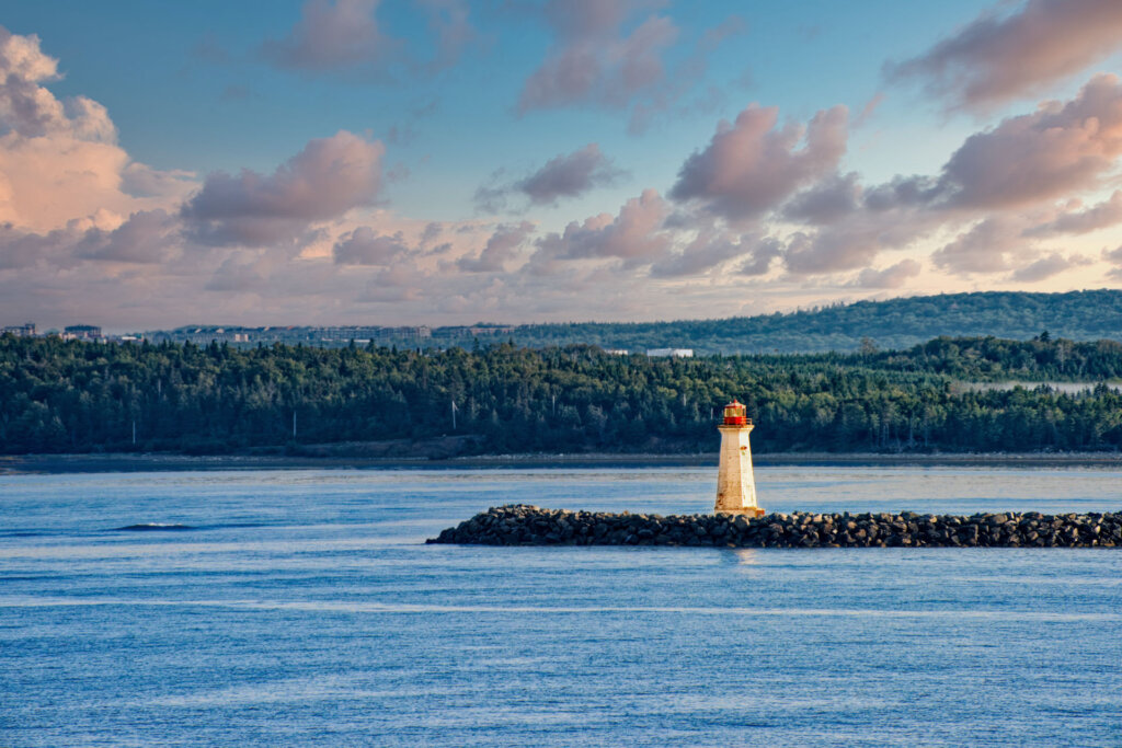The Maugher Beach Lighthouse stands guard at the end of McNabs Island which marks the entrance to Halifax harbor in Nova Scotia Canada - Copyright Randy G Barney Photography.