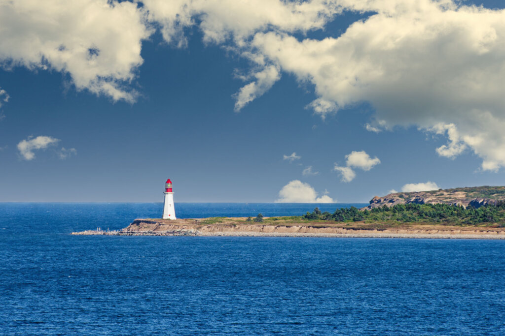In the distance is the Low Point Lighthouse at the tip of Sydney Harbor in Nova Scotia. - Copyright Randy G. Barney Photography.